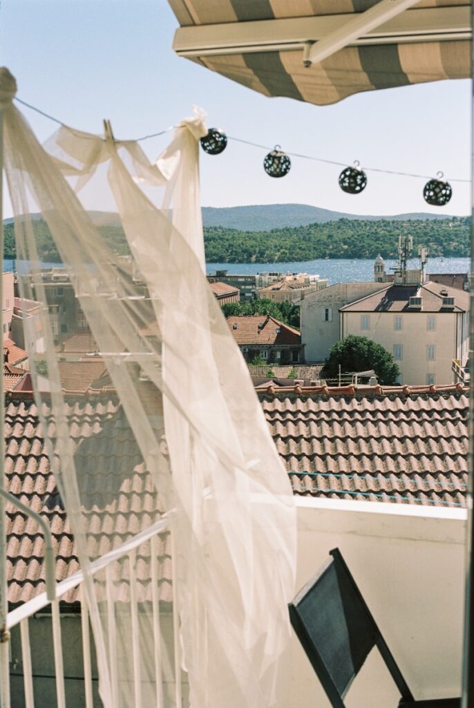 a chair on a balcony with a view of a city