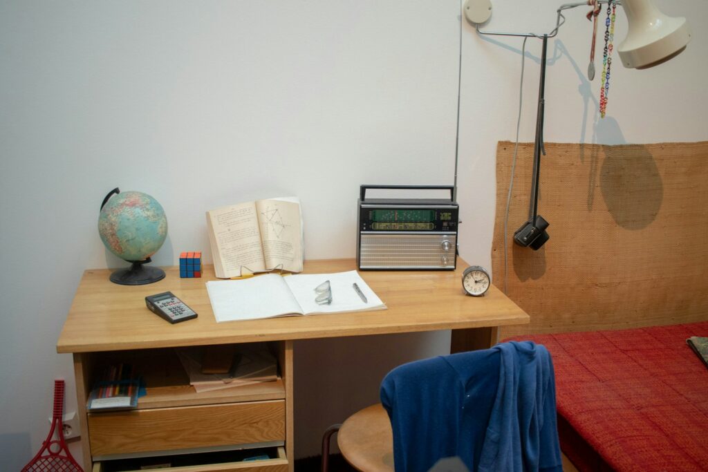 a bed room with a bed a desk and a radio