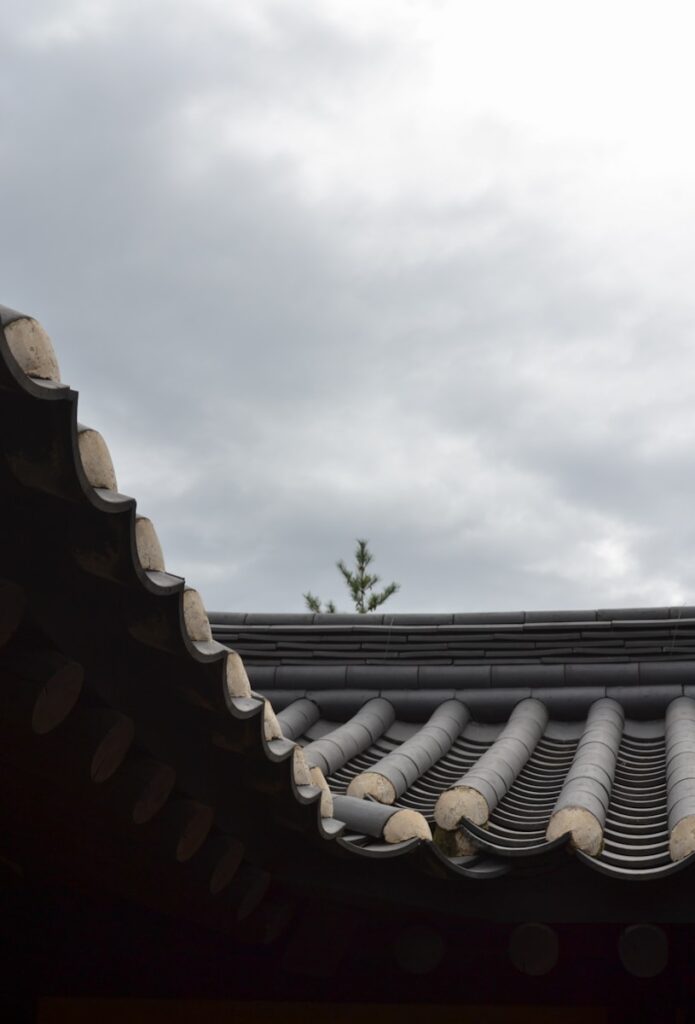 The roof of a building with a sky in the background